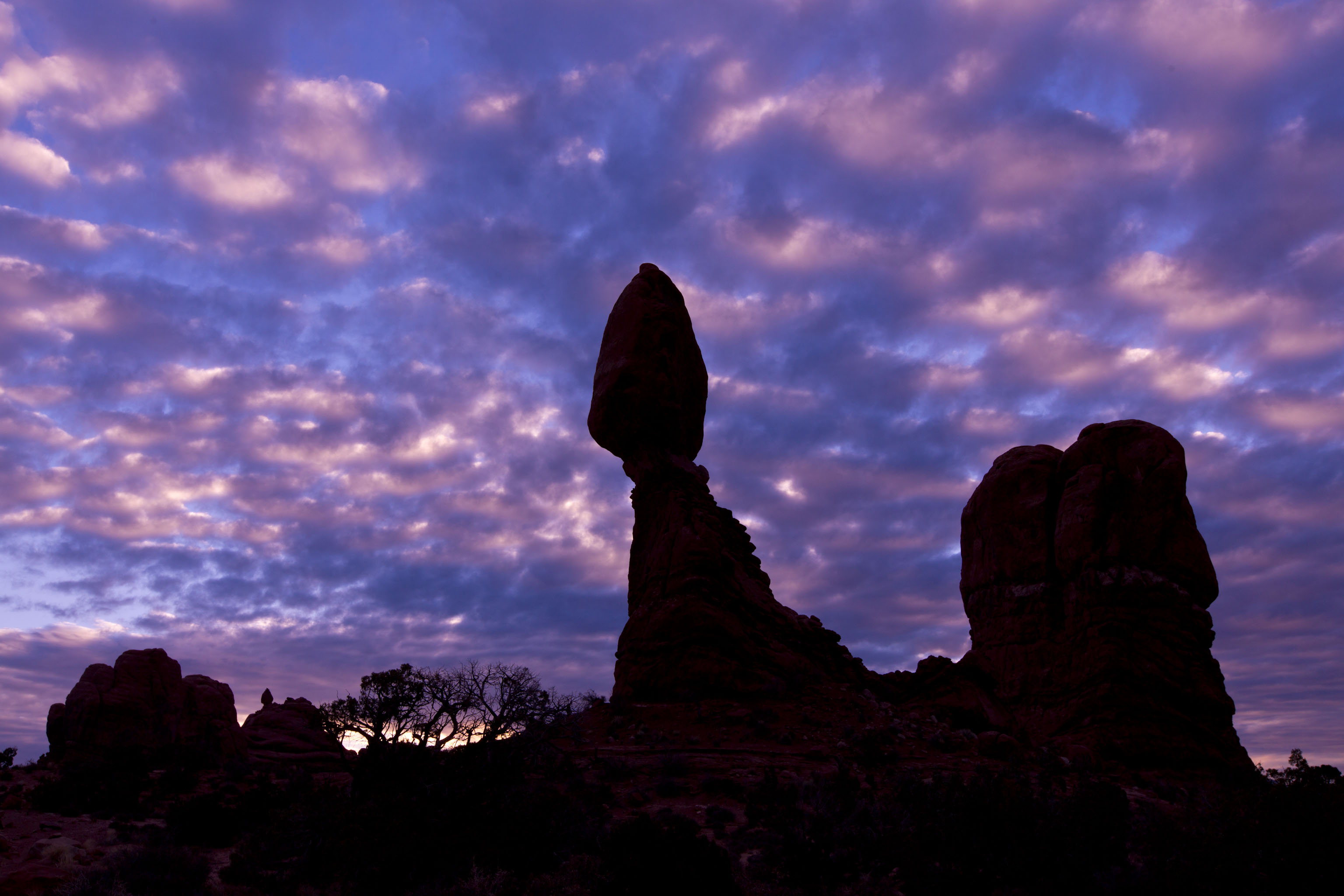 balanced rock clouds sunrise