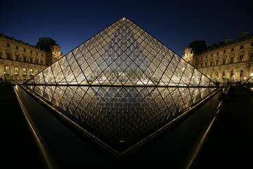 louve at night with pyramid, paris, france, water reflection