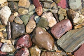 skipping stones rocks along shore of st. marys lake glacier national park photo